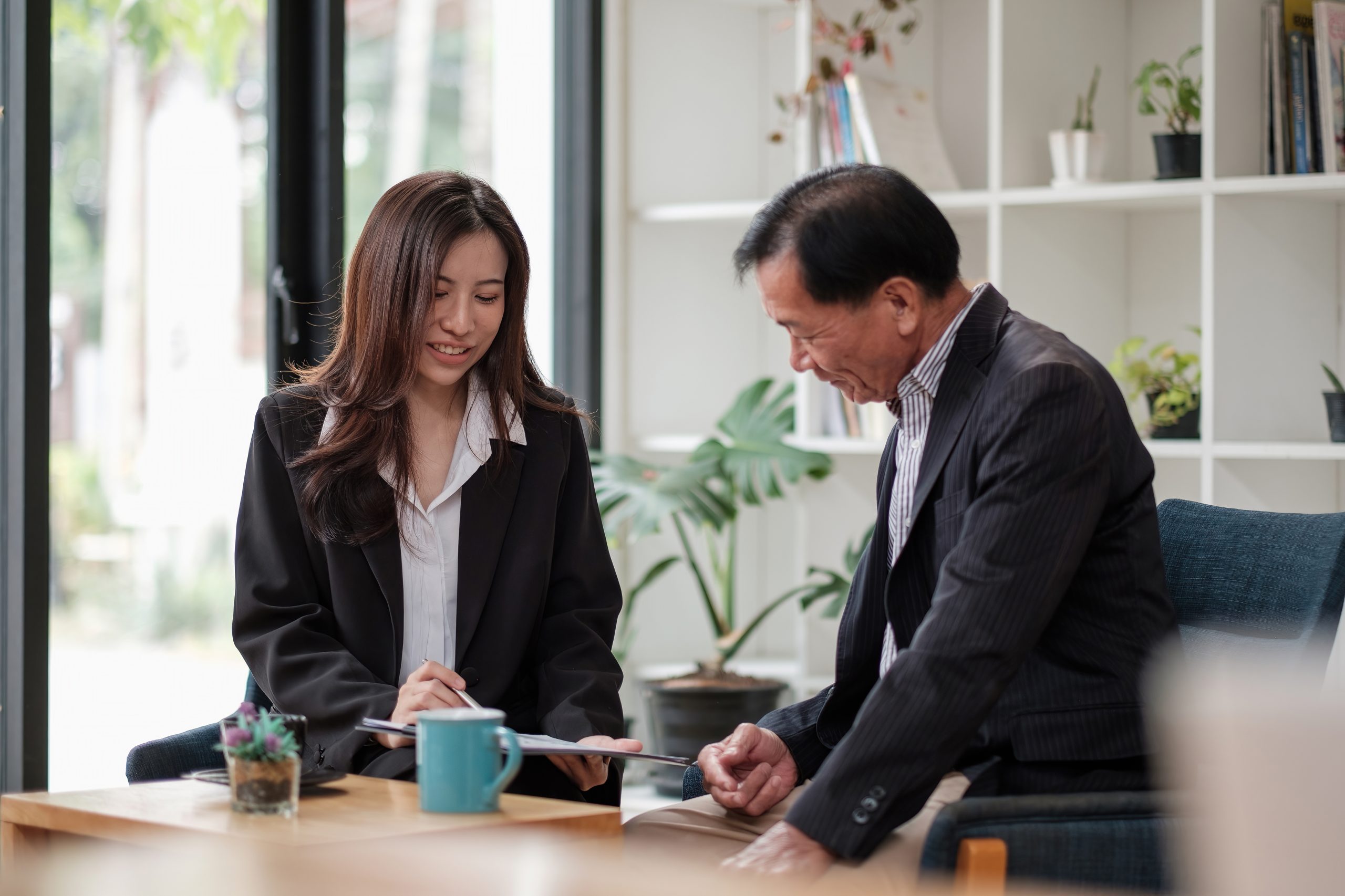 Friendly lawyer or financial advisor in suit consulting elder man, smiling investment broker or bank worker making loan offer, giving legal advice, selling insurance or real estate to customers